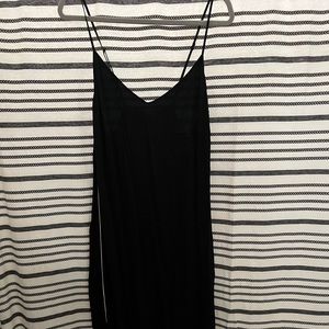 Black slip dress with white piping on the sides and snaps.